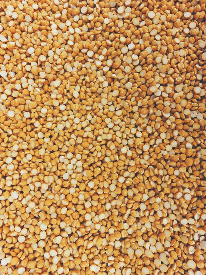 High-resolution image of dried yellow split peas, showcasing texture and pattern.